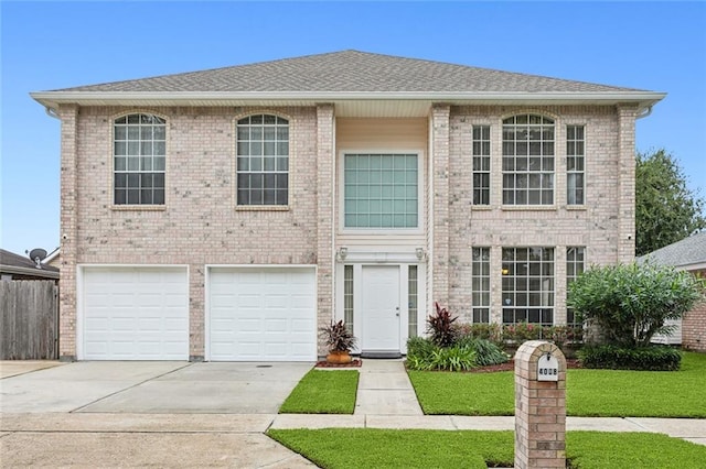 view of front of home with a front yard and a garage