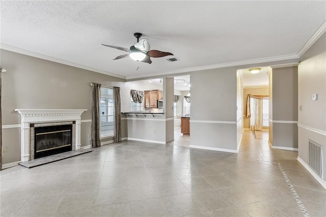 unfurnished living room with crown molding, a textured ceiling, and ceiling fan