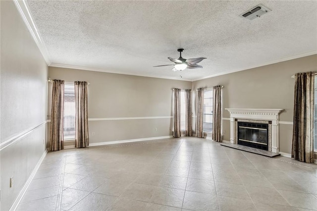 unfurnished living room featuring ceiling fan, ornamental molding, and a textured ceiling