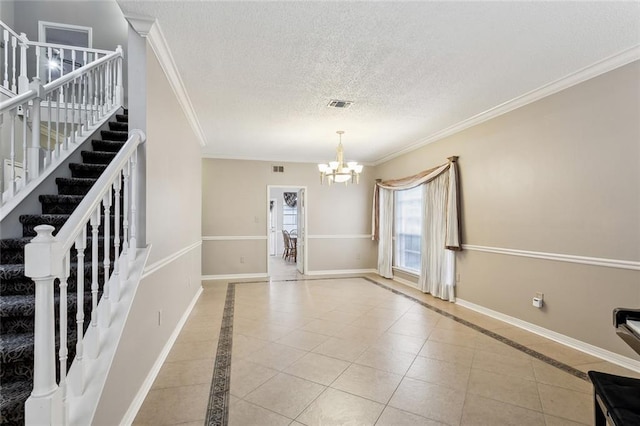 empty room with crown molding, light tile patterned flooring, and a chandelier