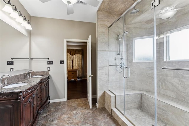 bathroom with vanity, ceiling fan, and a shower with door