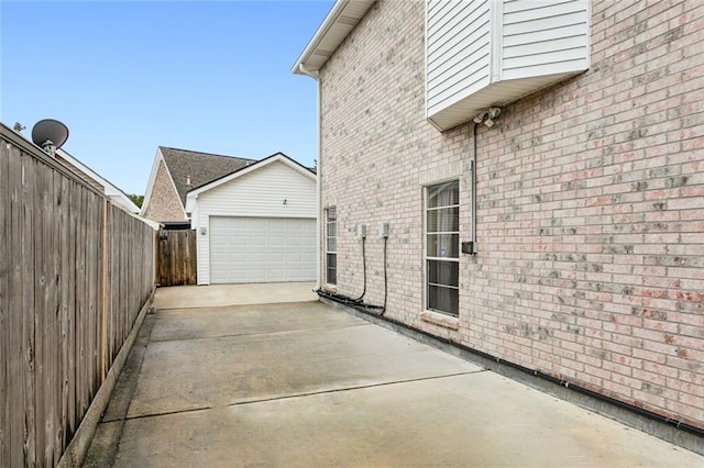 view of side of home with an outdoor structure and a garage