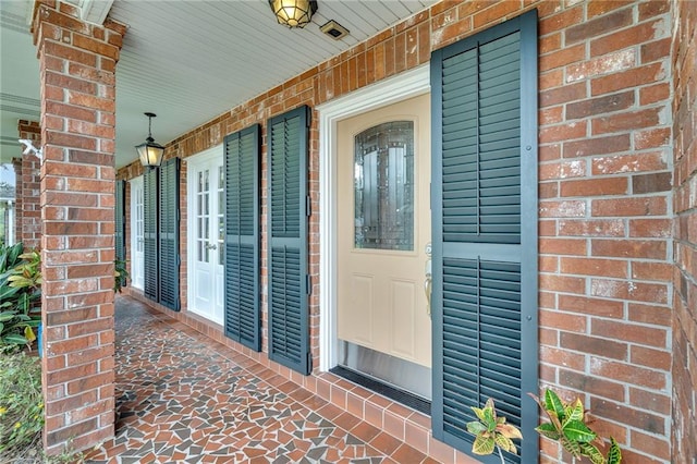 entrance to property featuring a porch