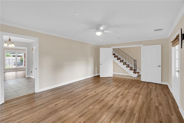 unfurnished living room with ceiling fan with notable chandelier, light hardwood / wood-style floors, and ornamental molding