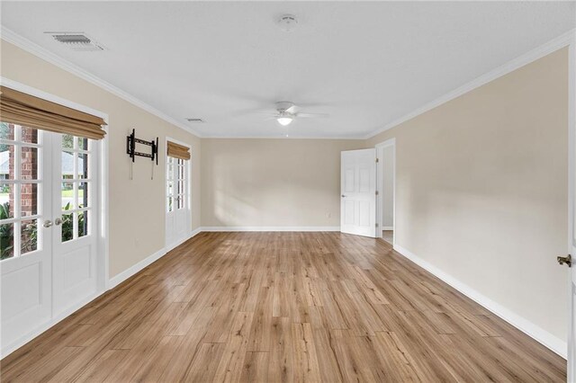 unfurnished room with crown molding, ceiling fan, and light hardwood / wood-style floors