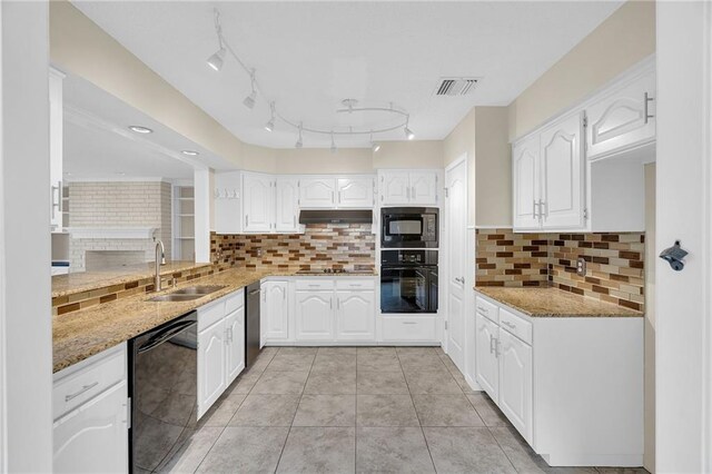 kitchen featuring light stone countertops, white cabinetry, and black appliances