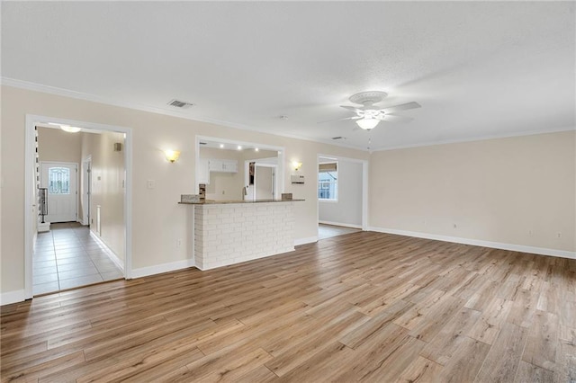 unfurnished living room featuring plenty of natural light and light wood-type flooring