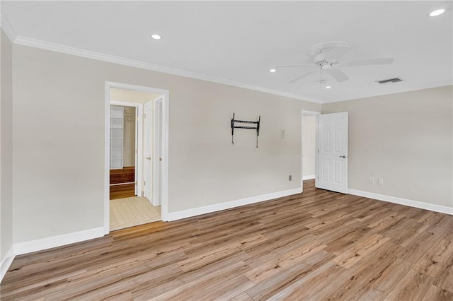 unfurnished room featuring ceiling fan, light hardwood / wood-style flooring, and ornamental molding