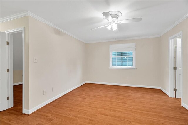 empty room featuring ceiling fan, light hardwood / wood-style floors, and ornamental molding