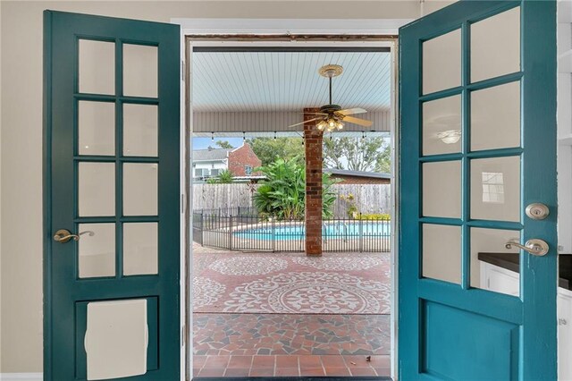 doorway to outside featuring ceiling fan