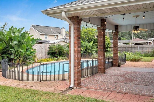 view of pool featuring ceiling fan and a patio