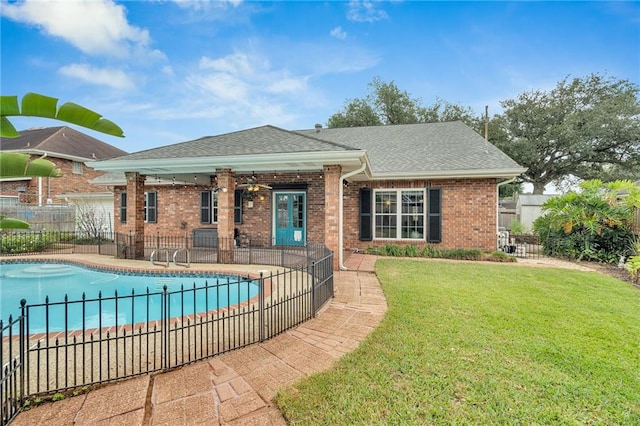 view of pool featuring ceiling fan, a yard, and a patio