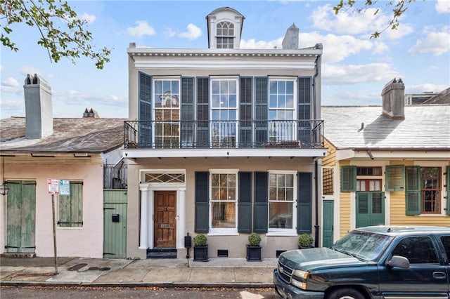 1216 Burgundy St, New Orleans, LA 70116 - view of front facade with a balcony and a chimney