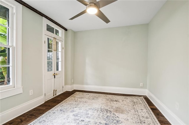 unfurnished room featuring dark wood-type flooring, ceiling fan, and a healthy amount of sunlight