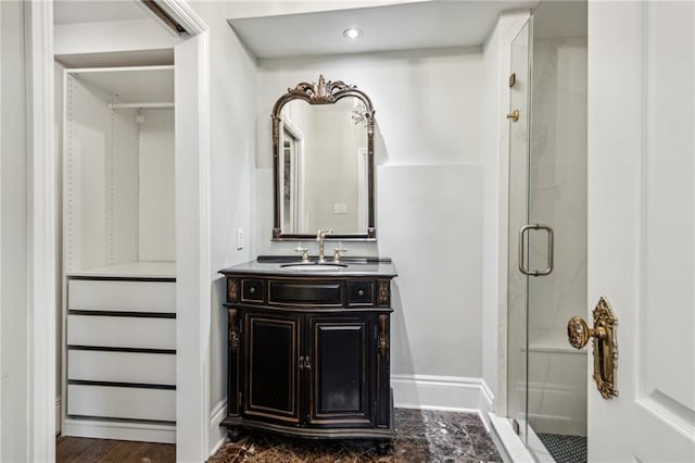 bathroom featuring vanity, hardwood / wood-style flooring, and a shower with shower door