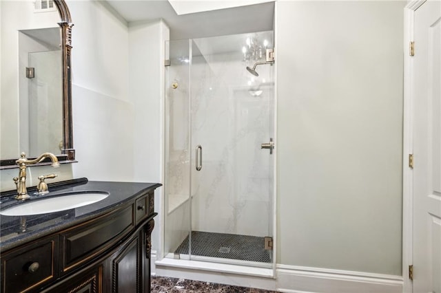 bathroom with vanity, an enclosed shower, and a skylight