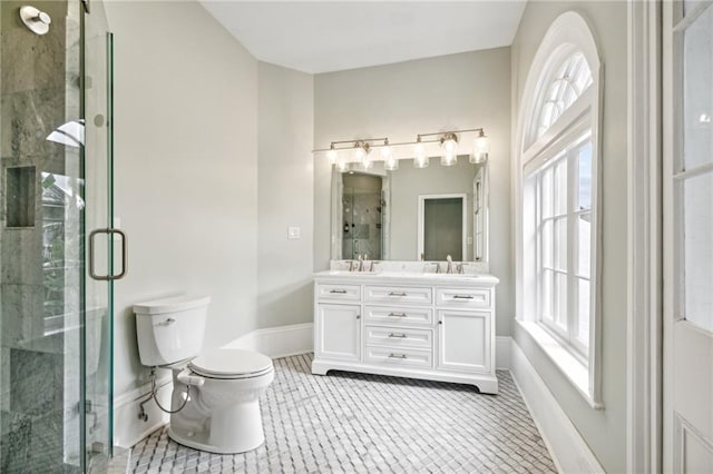 bathroom with tile patterned flooring, vanity, toilet, and a shower with shower door