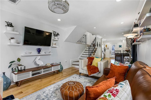 living room with hardwood / wood-style floors and crown molding