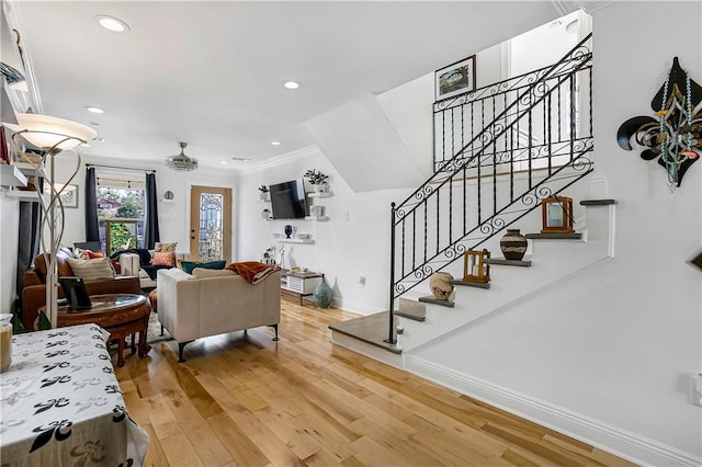 living room featuring wood-type flooring and ornamental molding