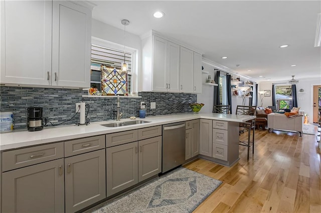 kitchen featuring sink, light hardwood / wood-style flooring, gray cabinetry, pendant lighting, and dishwasher