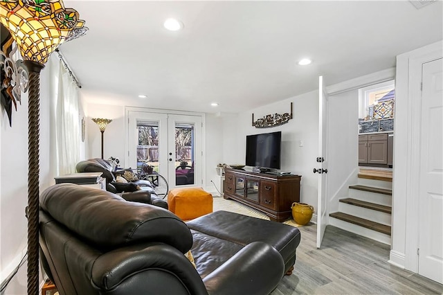 living room with french doors and light hardwood / wood-style floors