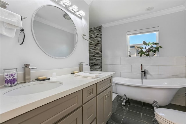 bathroom featuring vanity, crown molding, toilet, a bathtub, and tile walls