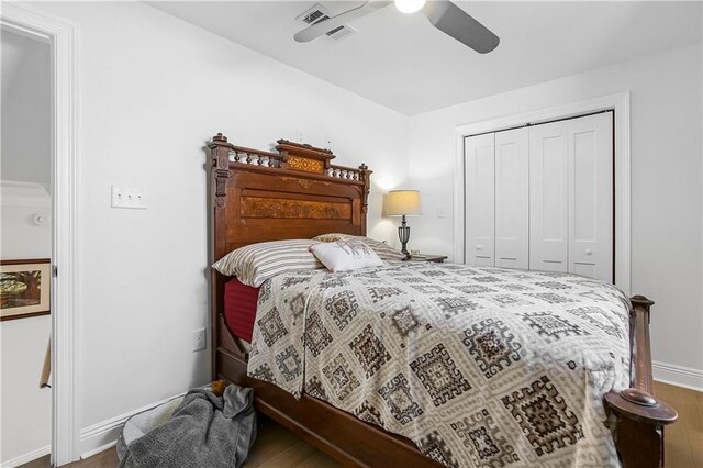 bedroom with a closet, hardwood / wood-style floors, and ceiling fan