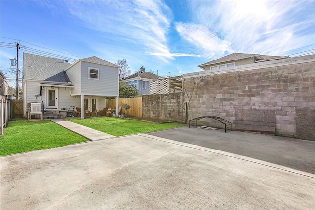 exterior space with a lawn and ac unit