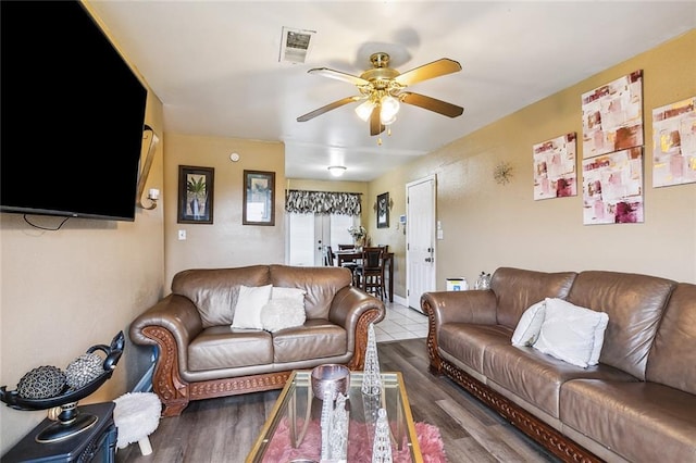 living room featuring hardwood / wood-style floors and ceiling fan