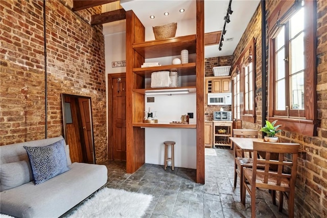 interior space with brick wall and track lighting