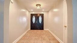 entryway with light tile patterned floors