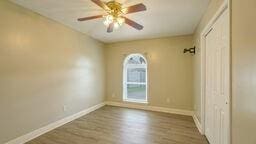 unfurnished room featuring hardwood / wood-style flooring and ceiling fan