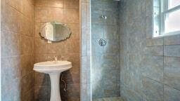 bathroom with a tile shower