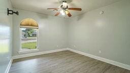 empty room featuring dark hardwood / wood-style floors and ceiling fan