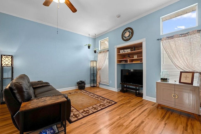 living room featuring light hardwood / wood-style floors, ceiling fan, and crown molding