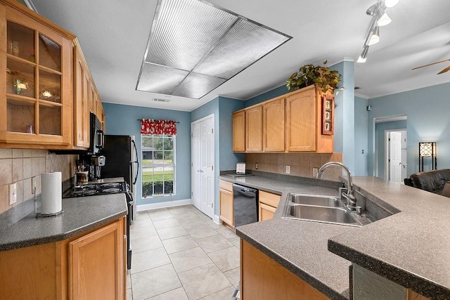 kitchen with sink, black appliances, kitchen peninsula, and tasteful backsplash