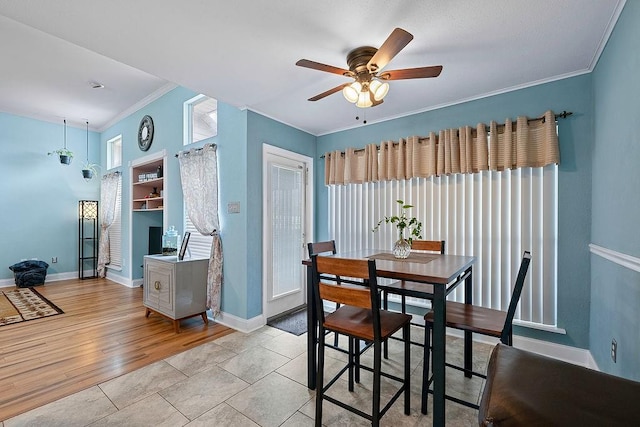 dining space with ceiling fan, light hardwood / wood-style floors, and crown molding