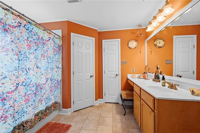 bathroom featuring tile patterned flooring and vanity