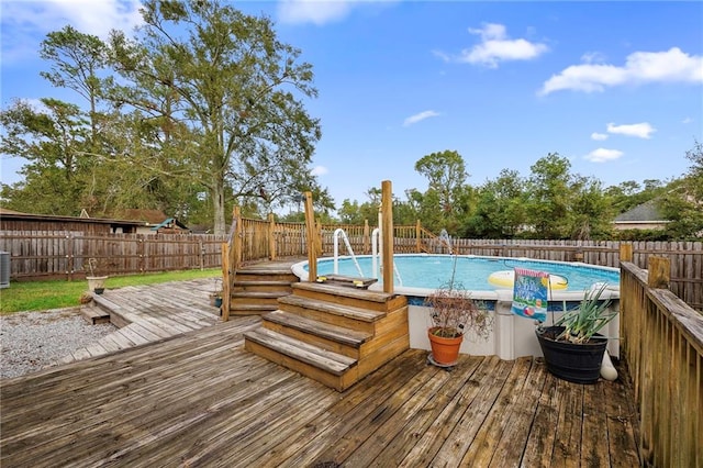 view of pool with central AC and a wooden deck