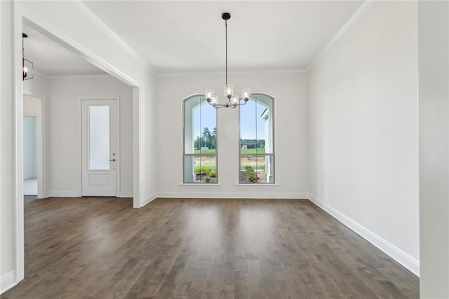 unfurnished dining area with ornamental molding, dark wood-type flooring, and a chandelier