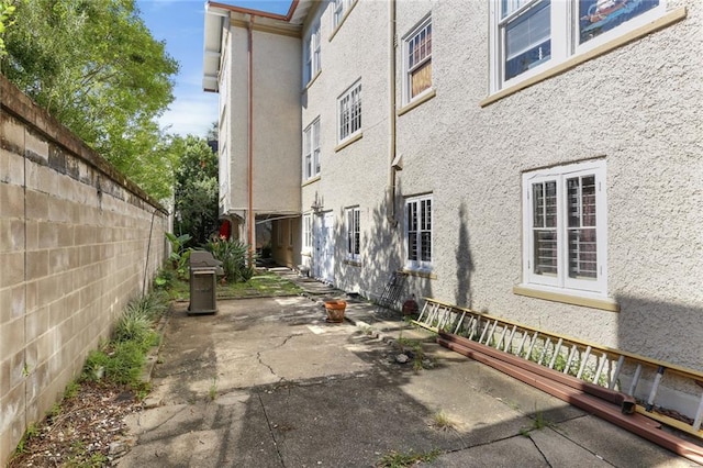 view of side of home featuring a patio area