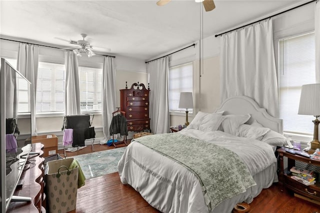 bedroom with ceiling fan and dark hardwood / wood-style floors