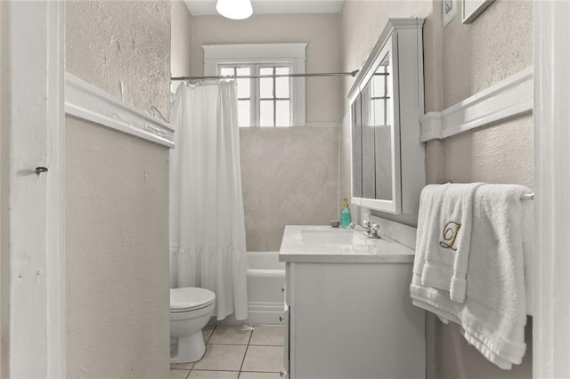 full bathroom with toilet, vanity, shower / bath combo with shower curtain, and tile patterned flooring