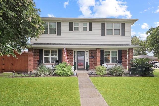 view of front of home with a porch and a front lawn