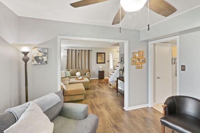 living room featuring ceiling fan and light hardwood / wood-style floors