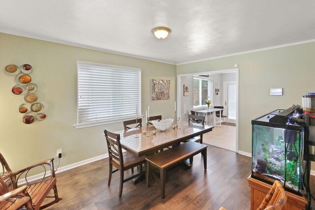 dining area featuring dark hardwood / wood-style flooring and ornamental molding