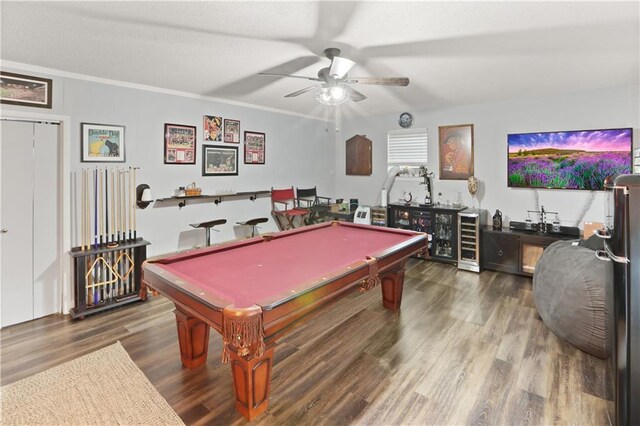 game room with billiards, indoor bar, hardwood / wood-style flooring, ceiling fan, and ornamental molding