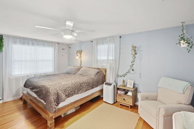 bedroom featuring hardwood / wood-style flooring and ceiling fan