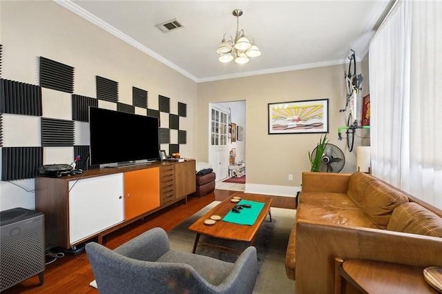 living room featuring ornamental molding, dark hardwood / wood-style flooring, and an inviting chandelier