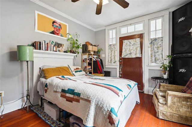 bedroom with hardwood / wood-style floors, ceiling fan, and crown molding